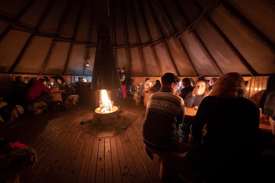 From Tromsø: Northern Lights Visit at Camp Tamok - Dinner in the Sámi lavvu: warm stew, open fire, and a calmer kind of magic
