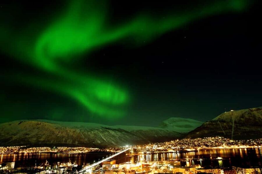 Tromsø: Evening dinner cruise with possible northern lights - Entering Tromsø at night: what this cruise really is